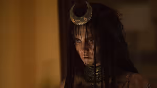 Enchantress (Cara Delevingne) stares ahead beneath a crescent-shaped headpiece