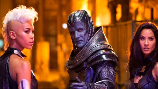 Apocalypse (Oscar Isaac) stands between white-haired Storm and Psylocke in a burning city