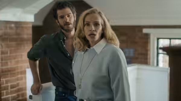 Alma Imhoff (Julia Roberts) and Hank Gibson (Andrew Garfield) standing in brick-walled interior