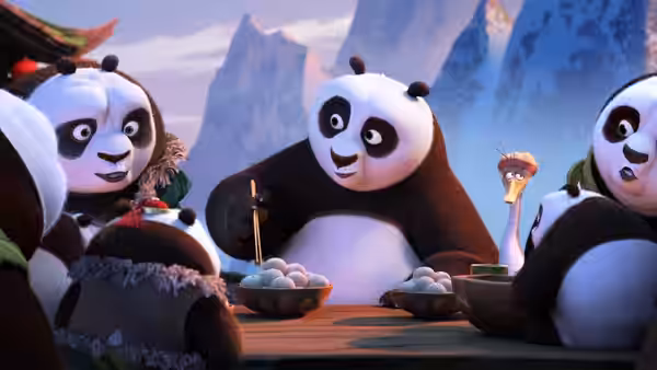 Po shares a table of dumplings with pandas in a mountain village