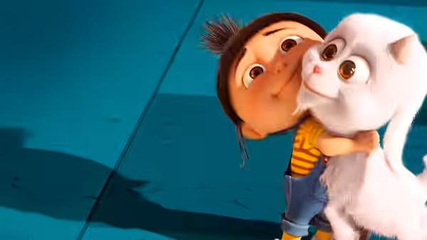 Agnes hugs a fluffy white unicorn toy against a turquoise floor