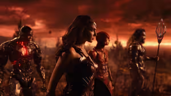 Wonder Woman leads Cyborg, the Flash, and Aquaman across a battlefield beneath a red sky