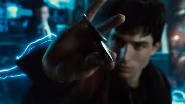 Barry Allen reaches toward a suspended object as blue lightning crackles around him