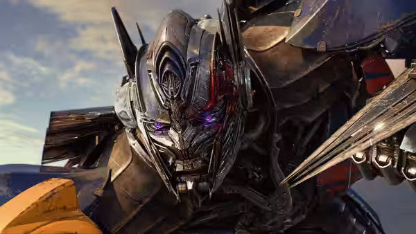 A menacing armored robot leans forward beneath an open sky