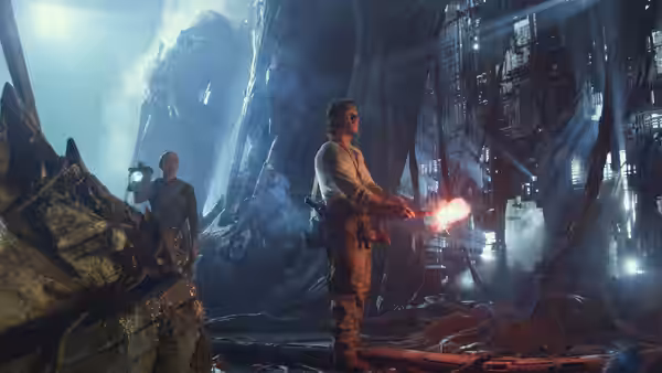 Cade Yeager (Mark Wahlberg) holds a glowing tool inside a vast wreckage-filled cavern