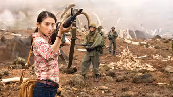 San Lin (Jing Tian) aims a rifle among scattered bones as soldiers follow