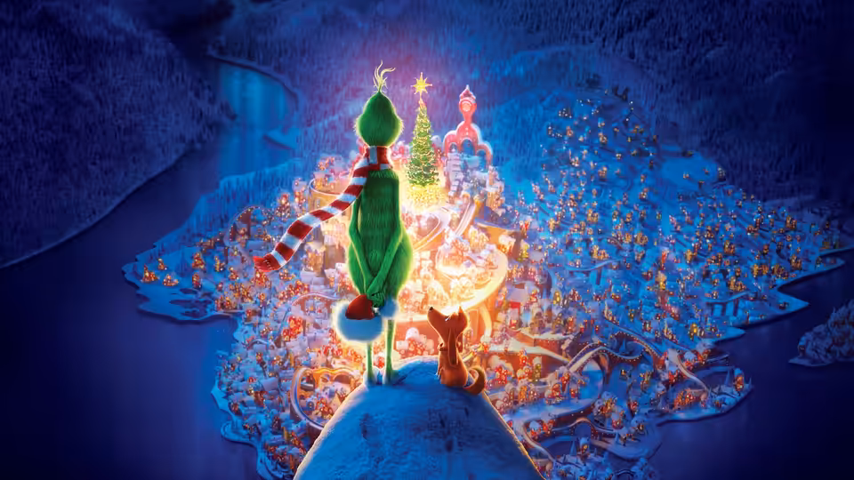 The Grinch and Max overlook the brightly lit, snow-covered town of Whoville