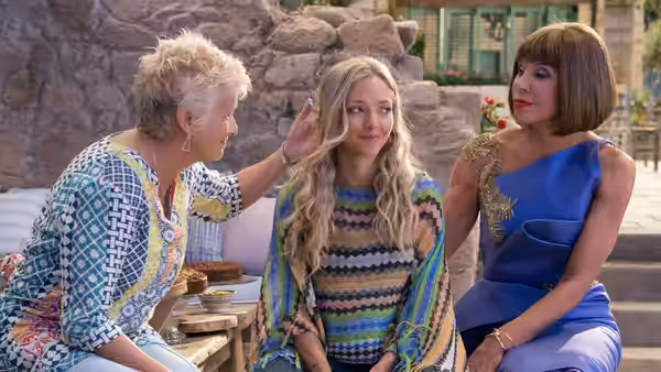 Rosie (Julie Walters), Sophie (Amanda Seyfried) and Tanya (Christine Baranski) sit together outdoors