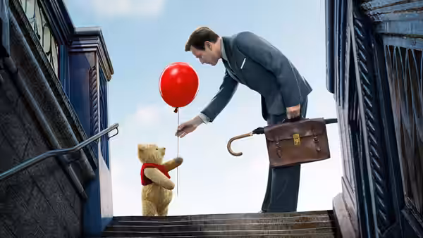 Christopher Robin offers Winnie the Pooh a red balloon on a city stairway