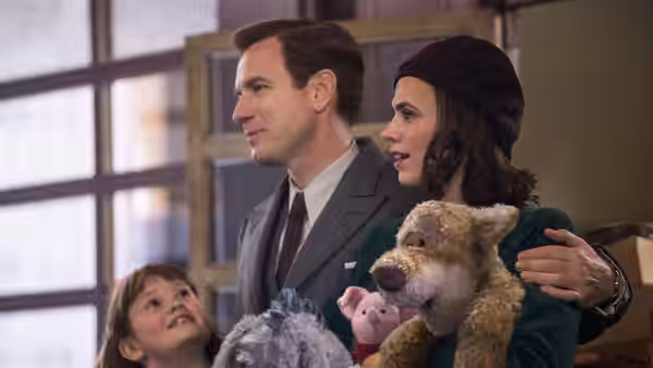Christopher and Evelyn Robin stand with Madeline among stuffed animals