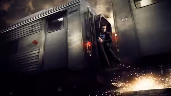 Michael MacCauley (Liam Neeson) clings to the side of a moving train as sparks fly