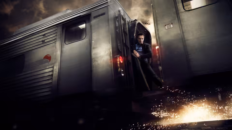 Michael MacCauley (Liam Neeson) clings to the side of a moving train as sparks fly