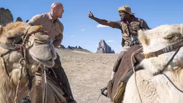 Dr. Smolder Bravestone (Dwayne Johnson) and Franklin Finbar (Kevin Hart) ride camels through the desert