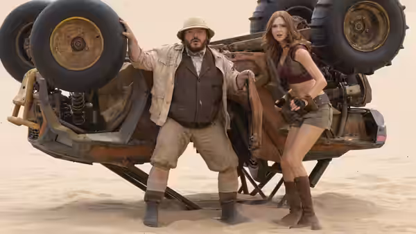 Professor Sheldon Oberon (Jack Black) and Ruby Roundhouse (Karen Gillan) stand beside an overturned vehicle