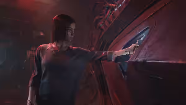 Alita (Rosa Salazar) reaches toward a control panel in a dim, industrial room