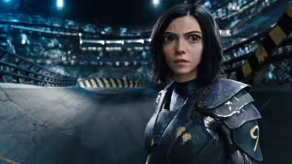 Alita (Rosa Salazar) stands in armor inside a crowded motorball arena