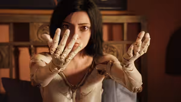 Alita (Rosa Salazar) raises her newly assembled hands in a warmly lit room