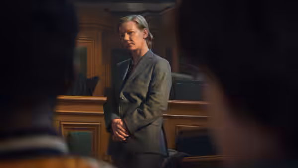 Sandra Voyter stands in a courtroom with hands clasped before her