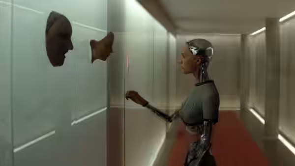 Ava (Alicia Vikander) reaches toward panels on a wall in a corridor