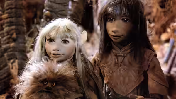 Kira and Jen look down at Fizzgig among the trees