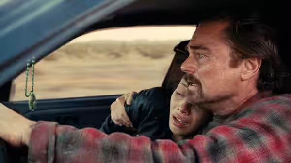 Bob (Leonardo DiCaprio) drives with Willa (Chase Infiniti) crying beside him