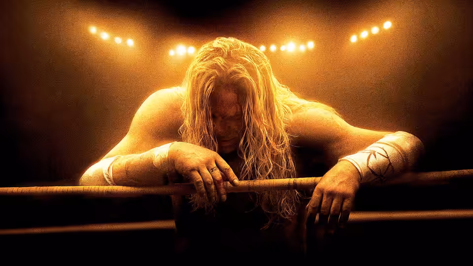 Randy (Mickey Rourke) leaning exhausted over the wrestling ring ropes