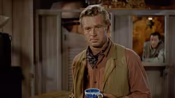 Johnny (Sterling Hayden) holds a mug inside a room