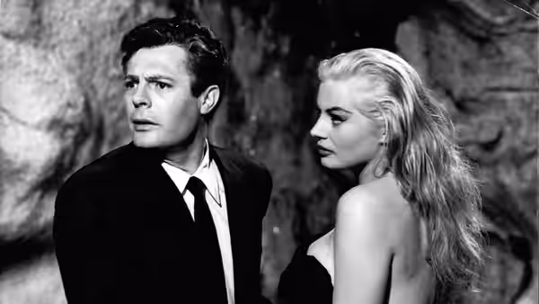 Marcello Rubini (Marcello Mastroianni) and Sylvia (Anita Ekberg) stand together among stone ruins