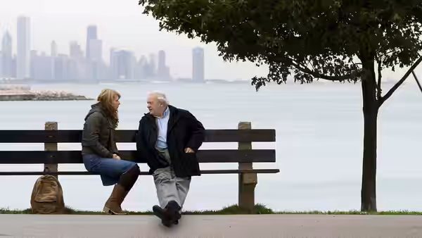 Catherine (Gwyneth Paltrow) and Robert (Anthony Hopkins) talk on a bench beside the water
