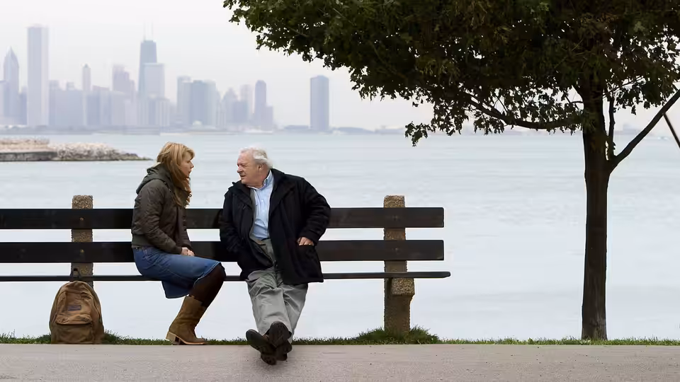 Catherine (Gwyneth Paltrow) and Robert (Anthony Hopkins) talk on a bench beside the water
