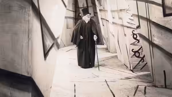 Dr. Caligari walking through the distorted painted alley with cane
