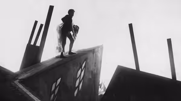 Cesare carrying Jane across the angled rooftops of the town
