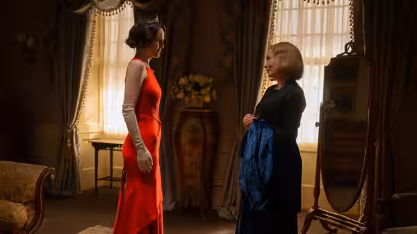 Lady Mary (Michelle Dockery) facing another woman in a bedroom