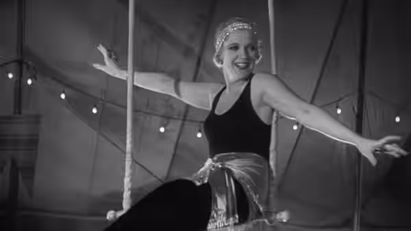 Cleopatra (Olga Baclanova) dances with her arms outstretched beneath strings of lights