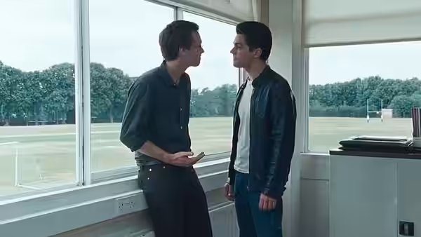 Irwin (Stephen Campbell Moore) and Dakin (Dominic Cooper) face each other beside the school playing field