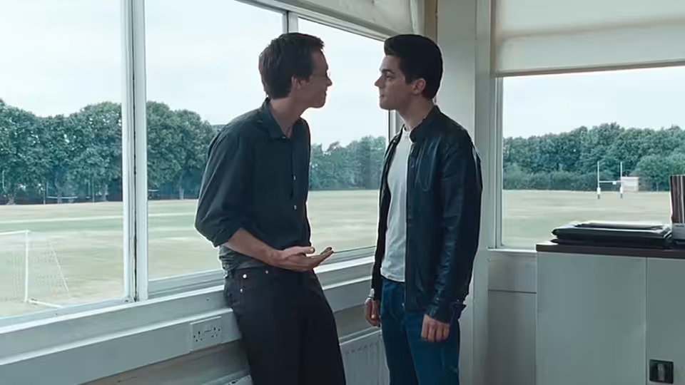 Irwin (Stephen Campbell Moore) and Dakin (Dominic Cooper) face each other beside the school playing field
