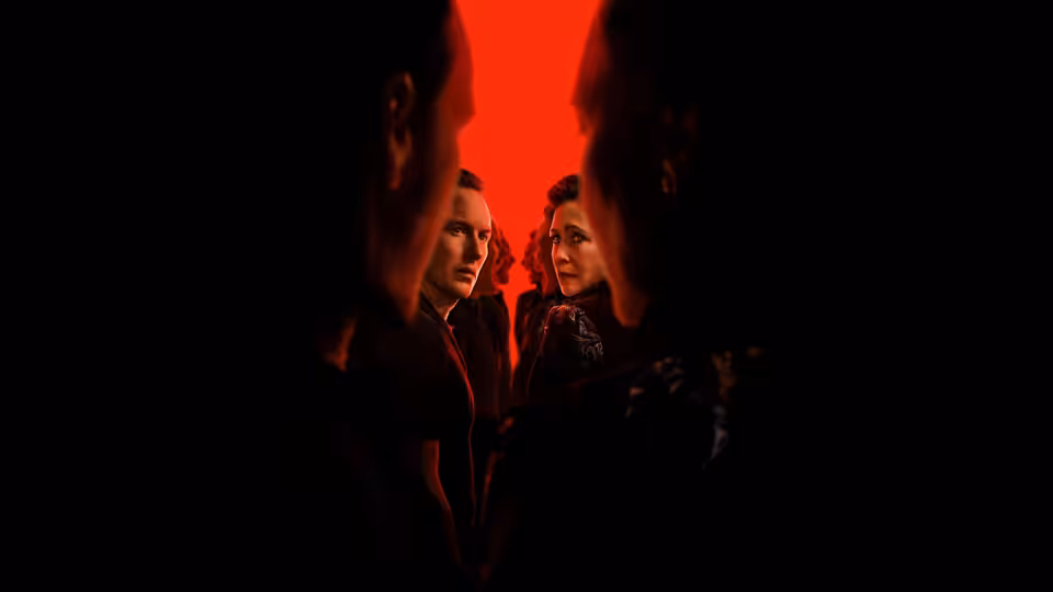 Ed Warren (Patrick Wilson) and Lorraine Warren (Vera Farmiga) facing forward in red light