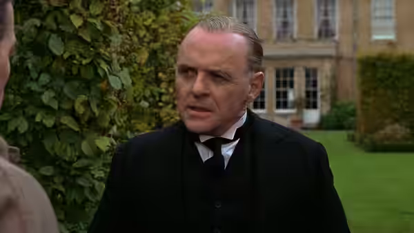 James Stevens (Anthony Hopkins) speaking outside a large country house