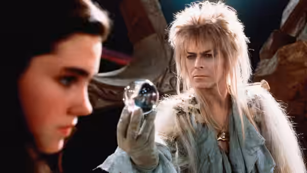 Jareth (David Bowie) holding a crystal ball near Sarah (Jennifer Connelly)