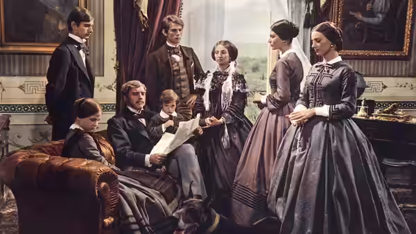 A group gathers in a drawing room as a seated man reads a letter