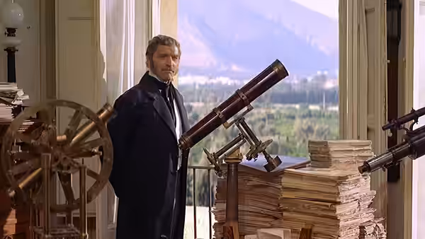 Prince Fabrizio (Burt Lancaster) stands beside a telescope and stacks of books