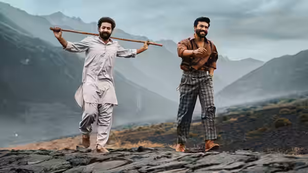 Komaram Bheem (N.T. Rama Rao Jr.) and Alluri Sitarama Raju (Ram Charan) walk along a mountain path