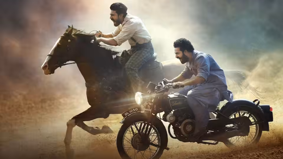 Komaram Bheem (N.T. Rama Rao Jr.) rides a horse beside Alluri Sitarama Raju (Ram Charan) on a motorcycle
