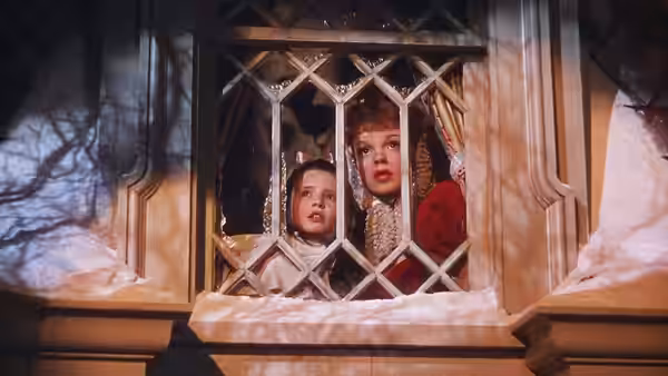 Esther Smith and Tootie Smith peer outside through a leaded window