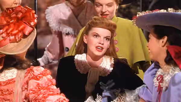Esther Smith (Judy Garland) looks at holiday finery with other girls in a shop