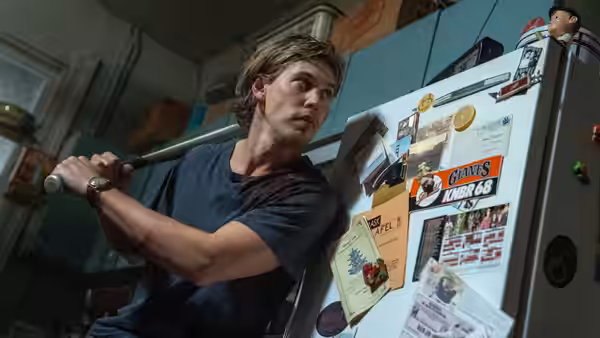 Hank Thompson (Austin Butler) gripping a baseball bat in a kitchen