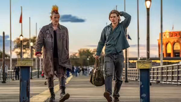 Russ (Matt Smith) and Hank Thompson (Austin Butler) walking on a pier at dusk