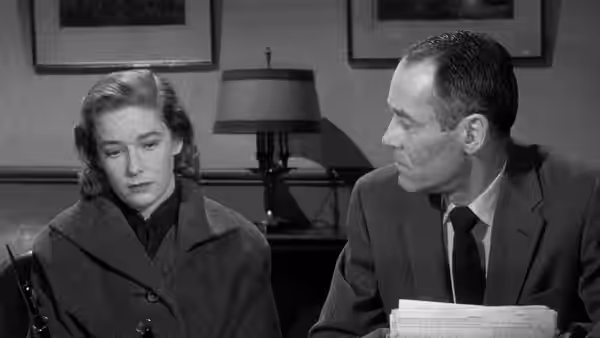 Rose Balestrero (Vera Miles) sits downcast beside Manny Balestrero (Henry Fonda) in an office