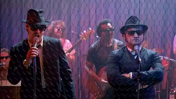 Jake Blues (John Belushi) and Elwood Blues (Dan Aykroyd) sing on stage before a band