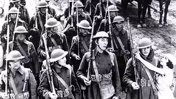 A woman marches among uniformed soldiers carrying rifles